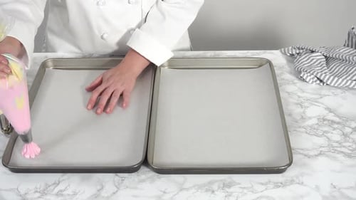 Chef Piping Icing on Cookie Sheet in Kitchen