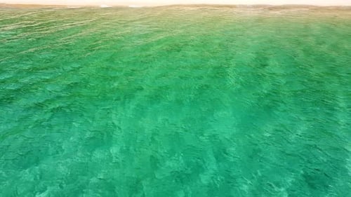 Sea waves and beautiful sand beach aerial view drone shot.