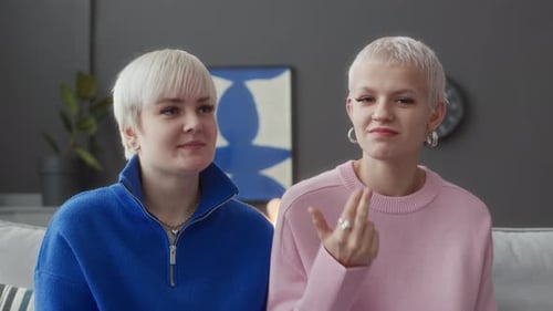 Young Adults Chatting Indoors with Hand Gestures