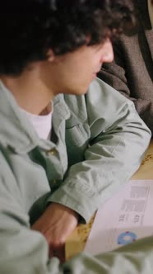 Young Adults Reviewing Charts in a Meeting