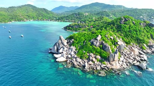 Rocky coastline with green forests and unique blue turquoise sea water.
