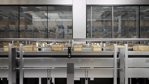 Packed Courier On Production Line Against Cardboard Boxes In Warehouse