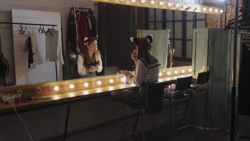 Young Woman Applying Makeup in Dressing Room