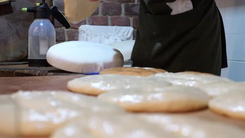 The Cook Putting the Dough on a Baking Pillow and Then Placing It in a Tandoor