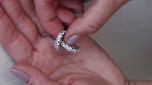 A Woman Shows Off Her Earrings. Vertical Video. Close Up.