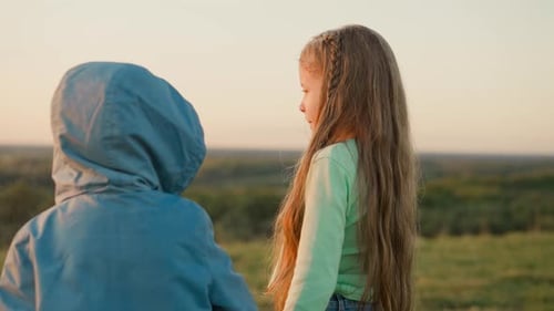 Friendly Children Enjoy Sun Shower in Sunset Field