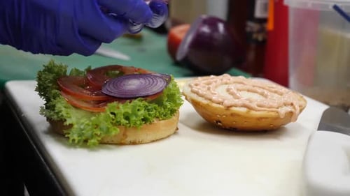 Burger Preparation with Fresh Ingredients in Restaurant