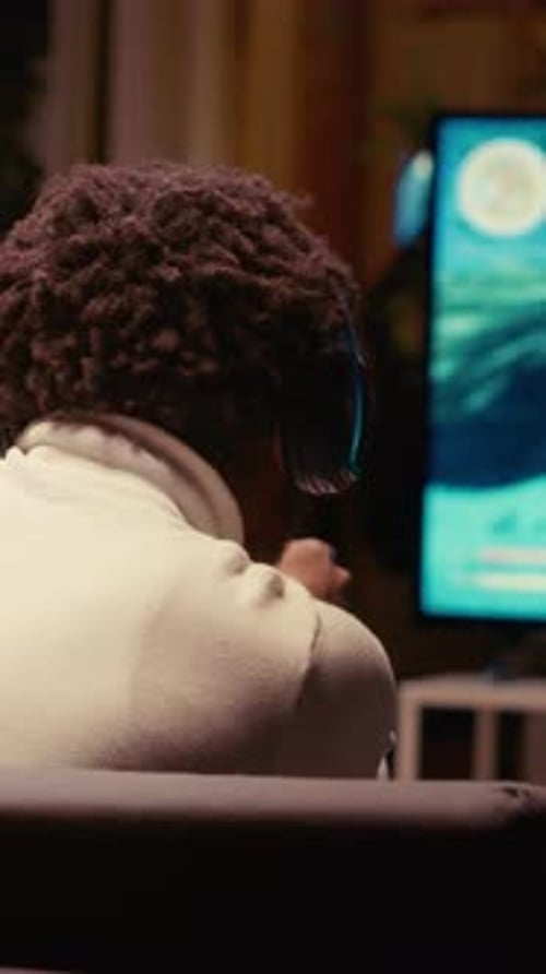 Vertical Video Man Playing on Gaming System Happy to Finally Solve Singleplayer Videogame Mission