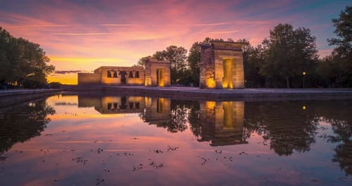 timelapse during colorful sunset at Templo de Debod, in Madrid, Spain. Reflection water pond