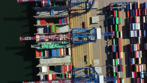 Container ship in export and import business and logistics. Shipping cargo to harbor by crane. Water