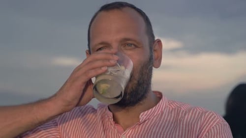 Young Man Admire View and Drinking Cocktail in Skybar 30s