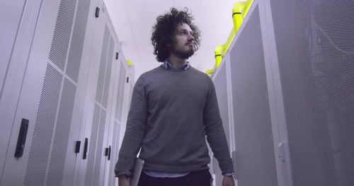 Man Walking Through Computer Server Room