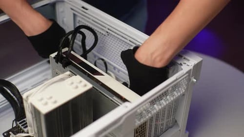Skilled Technician Male in Gloves Mounting Installing Fan in System Unit of Modern Desktop Computer