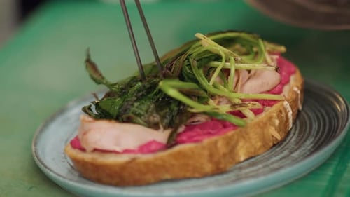 Open Sandwich Preparation with Meat and Fresh Herbs