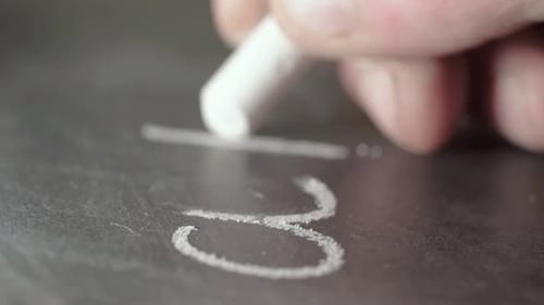 Chalk Drawing Numbers Close Up on Dark Surface