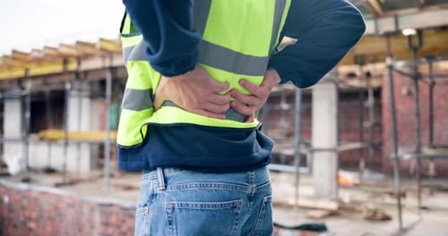 Construction, back pain or hands on site with massage, joint sprain or labor injury in building