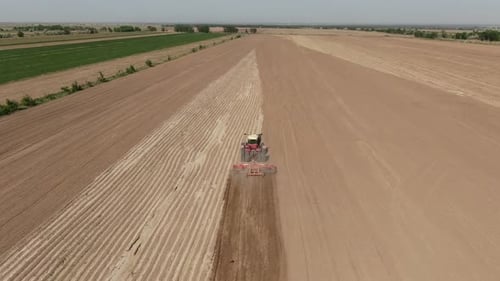 Tractor Tilling Field Aerial View