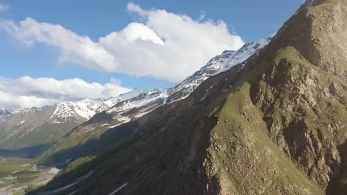 Aerial View and Climb with a View of the Rocky Mountains and Snowy Peaks