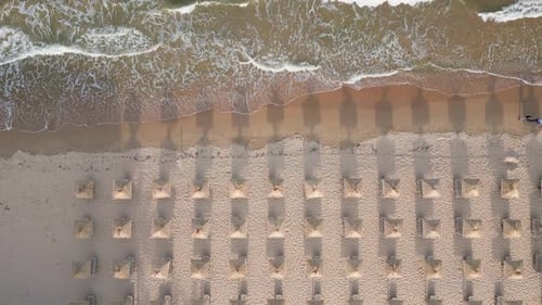 Aerial View of an Amazing Empty Sand Beach with Straw Beach Umbrellas and Turquoise Clear Water