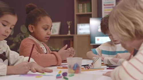 Children Drawing Together at Classroom Table