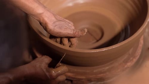 Hands Shaping Clay Bowl on Pottery Wheel