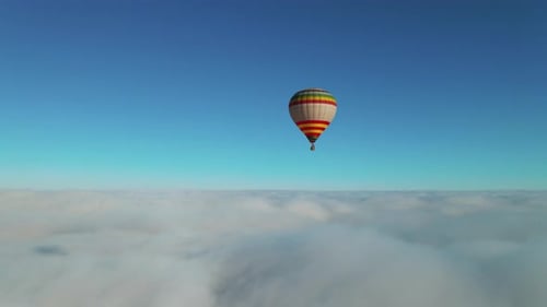 Hot Air Ballooning Above Clouds on a Sunny Day