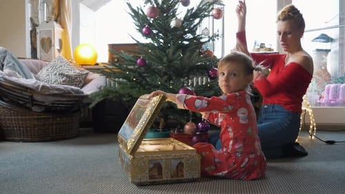Mother and Daughter Decorate Christmas Tree Together