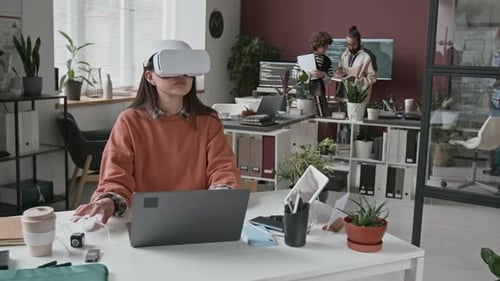 Young Adult Woman Using VR Headset in Office