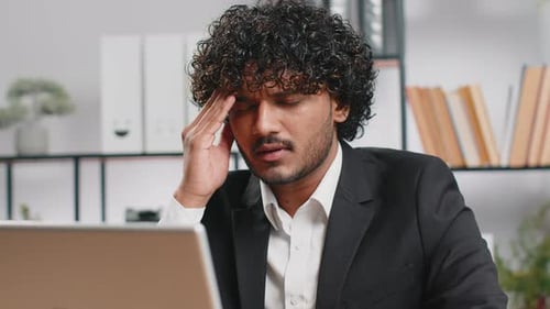 Tired Indian Business Man Suffering From Headache Problem Tension Migraine Stress at Home Office
