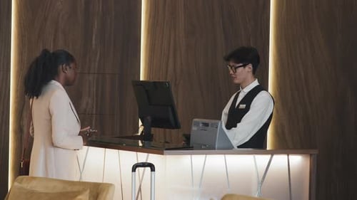 African American Woman Getting Room In Hotel