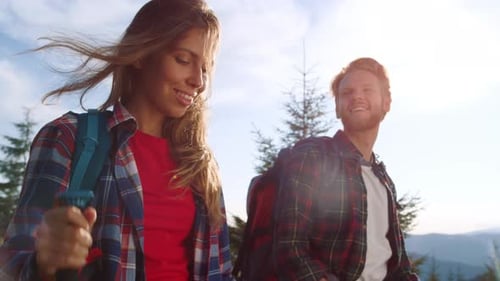 Couple Trekking Together On Sunny Mountain Hike