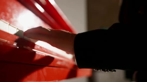Hands Playing Red Piano Close-up