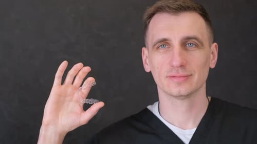 A Dentist Demonstrates Modern Aligners for Straightening Teeth