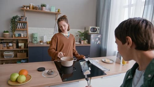 Teenagers Creating Cooking Content while Making Spaghetti