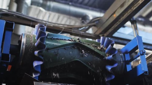 Small Rubber Pieces Fall Down From Moving Conveyor in Shop