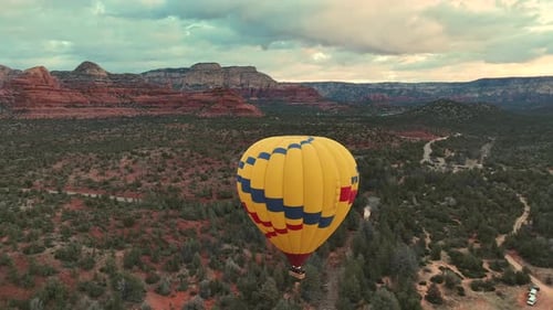 Hot Air Balloon Soaring Above Sedona Landscape At Sunrise In Arizona, USA. wide aerial