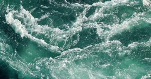 Blue waves of water of the river and the sea meet each other during high tide and low tide.