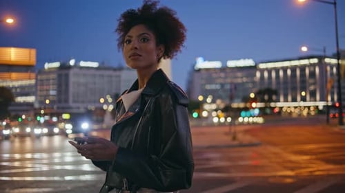 Brunette Standing Illuminated Street at Night Texting Cellphone Closeup