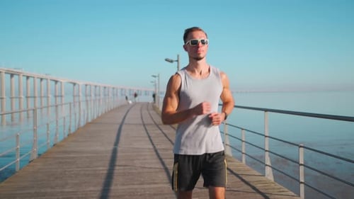 Male Athlete Running on Bridge