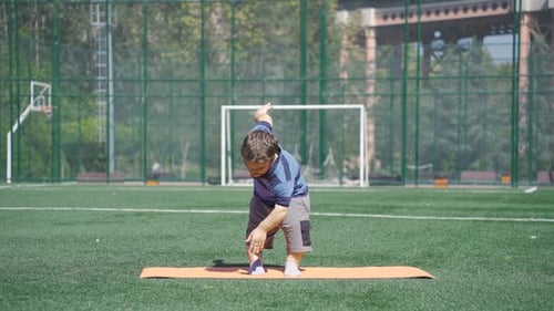 Man Exercising on Yoga Mat in Urban Park