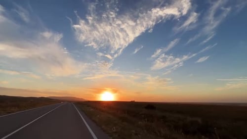 Traffic on the Road in the Crimea Against the Background of Sunset