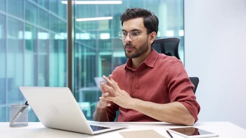 Young Adult In Office Having Video Conference