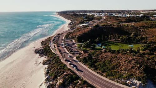 Coastal drive along the scenic beach at sunset with gentle waves and vibrant hues