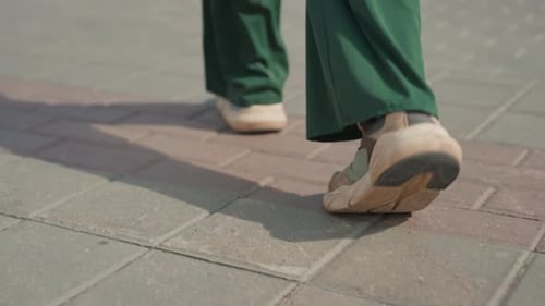 Walking Through Urban Streets Pavement Journey with Shadows and Pace Footsteps in City Showing