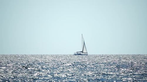 Sailing Ship Luxury Yacht with White Sails in the Sea in the Evening Sunlight