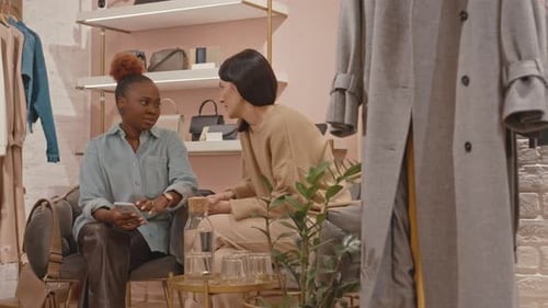 Multiethnic Female Friends Chatting in Designer Boutique