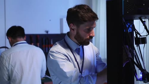 Young Adult Technical Specialist Looking on 3d Printer Thinking for Solution Couple Multiethnic