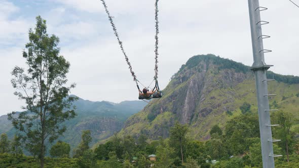 Girl Swinging on Giant Swing Against Picturesque Landscapes of Nuwara ...