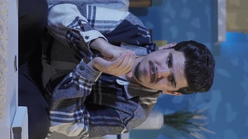 Man Rubs Hands Together Indoors Portrait Orientation