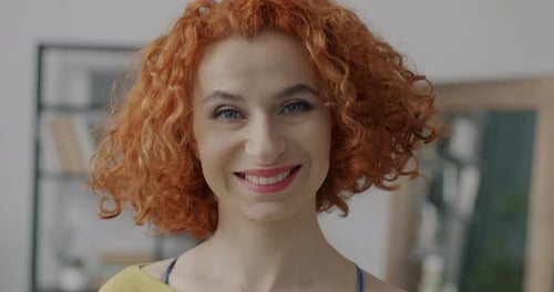 Close Up of Smiling Woman with Curly Red Hair